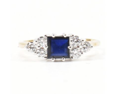 A hallmarked 9ct gold synthetic sapphire and cubic zirconia CZ. The ring set with a step cut&nbsp; synthetic sapphire flanked