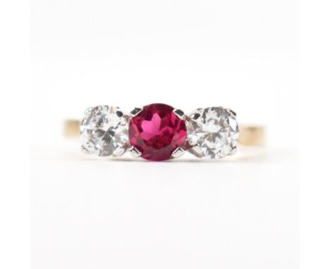 A hallmarked 9ct gold synthetic ruby and cubic zirconia CZ&nbsp; three stone ring. The ring set with a mixed cut synthetic ru