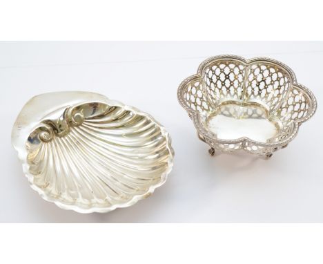 A silver shell shaped trinket dish, Birmingham 1915,  raised on three ball feet, together with A pierced bon bon dish, Birmin