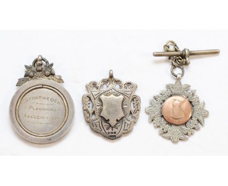 Two silver watch fobs, Birmingham 1905, 1910, together with a silver 'Stratheden Ploughing Association' medal, 74gm.