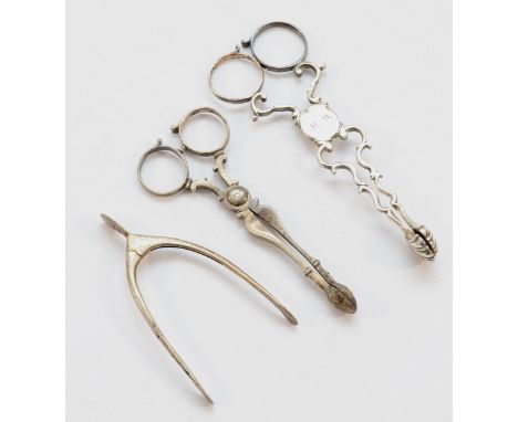 Two pairs of silver sugar nips, both not having town or date letter, together with a pair of wishbone shaped sugar tongs, Bir