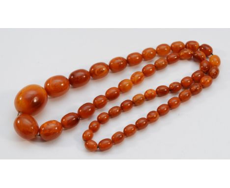 An amber graduated bead necklace, with screw clasp, largest bead 35mm, 95g