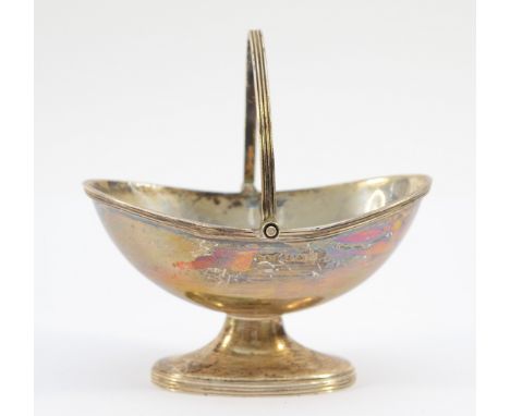 A silver dish raised on a pedestal having swing action handle, Birmingham 1974, 11cm with handle raised, 87gm.