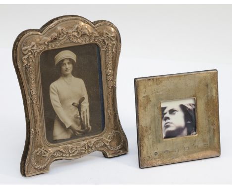 A silver photograph frame, Sheffield 1992, with embossed bow decoration, 21x15cm, together with a square 925 silver frame, Sh