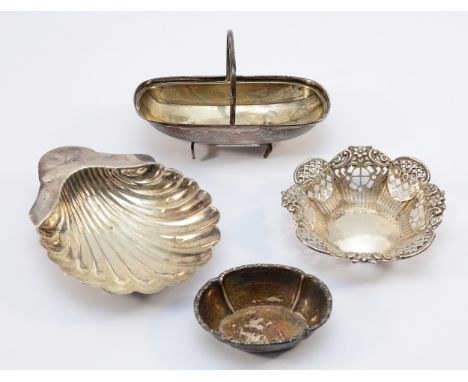 A silver shell shaped trinket dish raised on three ball feet, Birmingham 1908, together with a pierced silver dish, markings 