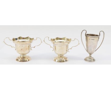 A pair of twin handled pedestal dishes, Birmingham 1938, together with a silver miniature twin handled trophy, Birmingham 193