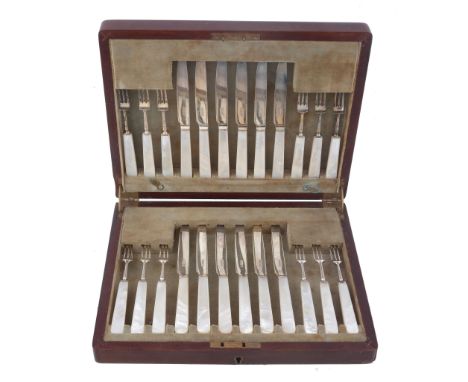  A set of twelve silver and mother of pearl handled fruit knives and forks by Thomas Bradbury  &  Sons,   Sheffield 1929, in 