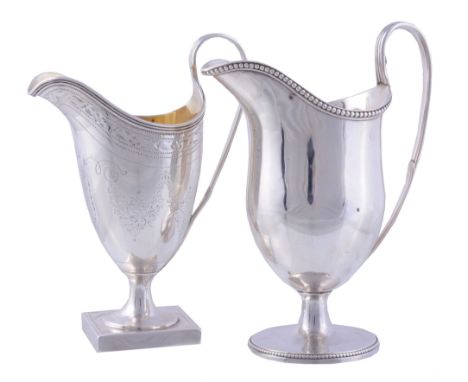 Two George III silver helmet shape cream jugs,   one by Thomas Oliphant,   London 1795, with bright cut borders and later en