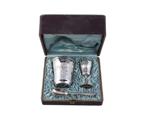  A mid- 20th century French silver christening set,   comprising: a beaker, an egg cup and a spoon,    engraved with ribbons 