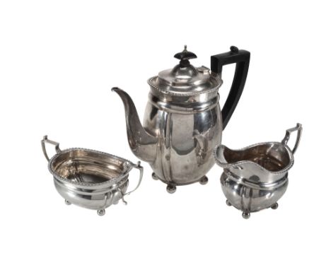  A silver swollen oblong three piece coffee service by C. S. Harris  &  Sons,   London 1925-26, the coffee jug with a composi