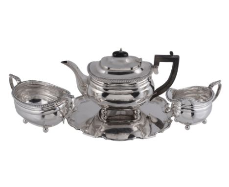  A silver oblong baluster three piece tea service by The Goldsmiths  &  Silversmiths Co. Ltd,   London 1911-12, the tea pot w