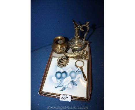 A brass fish door knocker, small brass magnifying glass, miscellaneous brass items and a teapot stand.