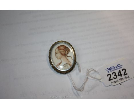 A Silver (800 marked) oval Pendant/Brooch encapsulating a portrait miniature of a Romanesque young lad with her hair in a bun