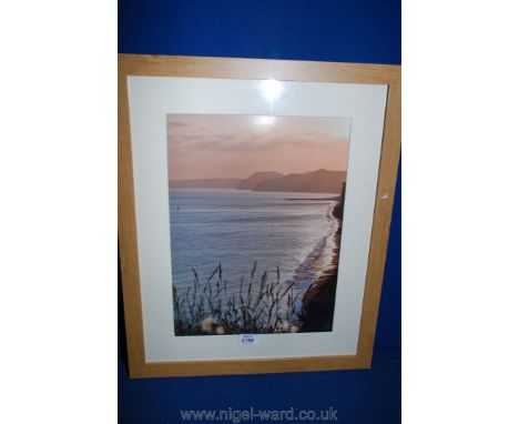 A framed and mounted Print of a British beach.