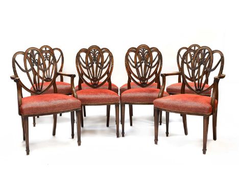 A set of eight Sheraton Revival shield back mahogany dining chairs, c.1900, with carved Prince of Wales' feathers and ribbon 