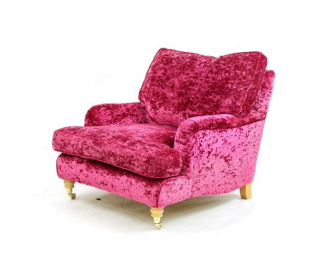 A modern Lansdowne armchair, in the manner of Howard & Sons, upholstered in vibrant fuchsia crushed velvet with matching arm 