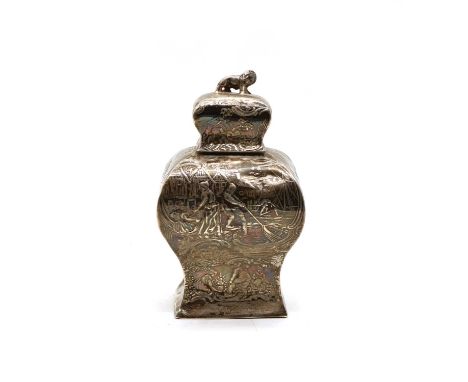 A Dutch silver tea caddy and cover, with lion finial, of shaped baluster form, embossed decoration of figures in the fieldsim