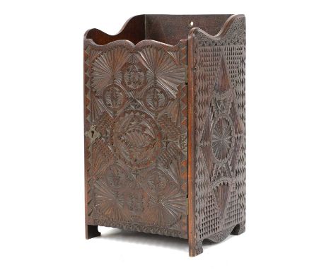 A Russian chip carved smoker's cabinet, with a shelf over a cupboard, enclosing a drawer, 21cm wide, 18cm deep, 37cm highCond