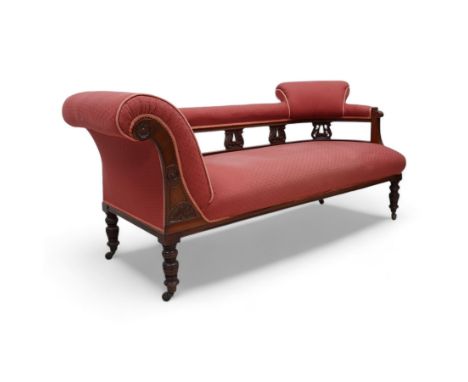 Late Victorian walnut chaise longue, upholstered in red fabric, scroll leaf and pierced splats, on ring turned feet with bras