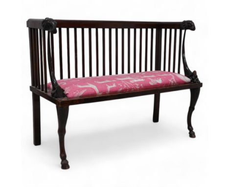 19th century mahogany two-seat bench, moulded cresting rail over slatted back with rams head carved terminal, the front arm s