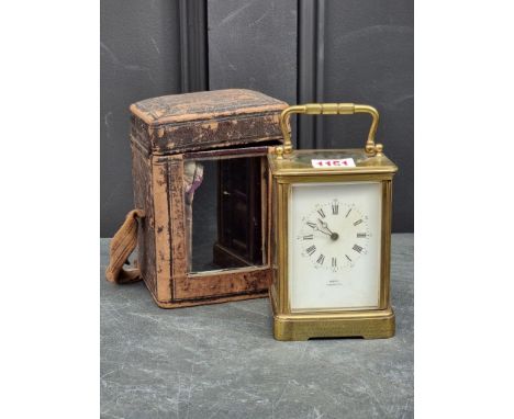 A Victorian brass carriage clock, striking on a gong, height including handle 17cm, with presentation inscription, in origina