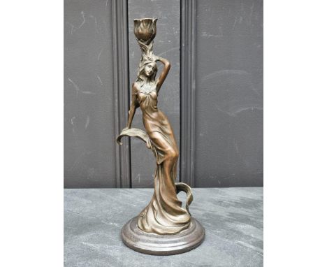 An Art Nouveau style bronzed resin figural candlestick, 33cm high.