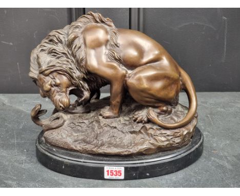 A bronze figure group of a lion and serpent, inscribed 'A Barye', on marble base, 28.5cm wide.