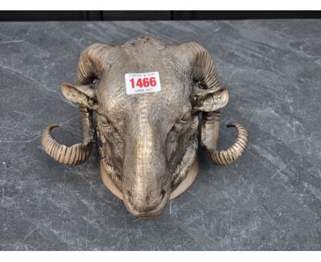 A silvered bronze ram's head, 14cm high.