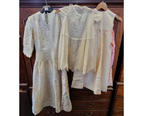 A vintage pale gold brocade dress; together with a child's cotton lace overdress; and a girls cream taffeta dress with a pink