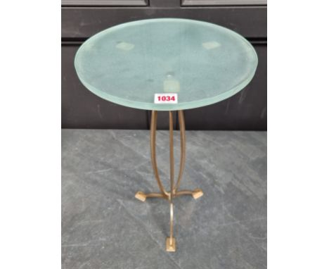 An Art Nouveau bronze and glass tripod table, attributed to Harris &amp; Sheldon, 55cm high x 31.5cm diameter.