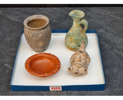 Antiquities: a group of Roman pottery and other items, to include a Samian Ware bowl, 10cm diameter; a jug, 12.5cm high; and 