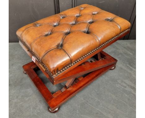 A good mahogany and studded buttoned leather gout stool, with double ratchet mechanism, 52cm wide.