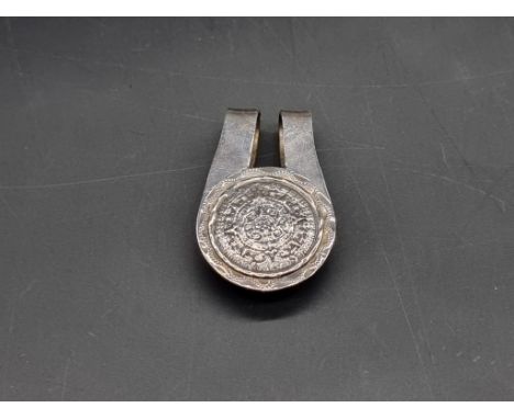 A Central American white metal money clip, 5cm long.