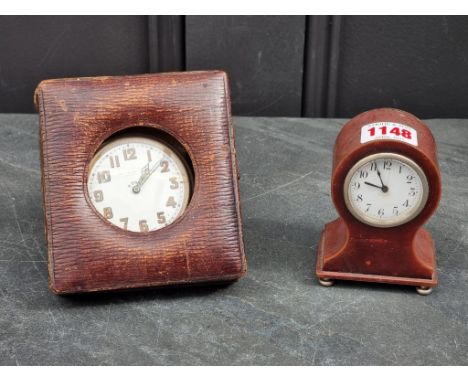 A small lacquered metal balloon timepiece, 9.5cm high, (cracks to dial); together with another nickel plated travelling clock