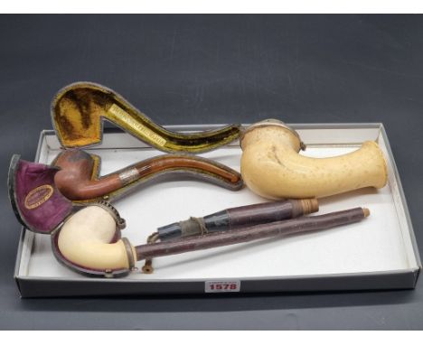 Two Continental meerschaum pipes, one partially cased; together with another silver mounted pipe. (3)