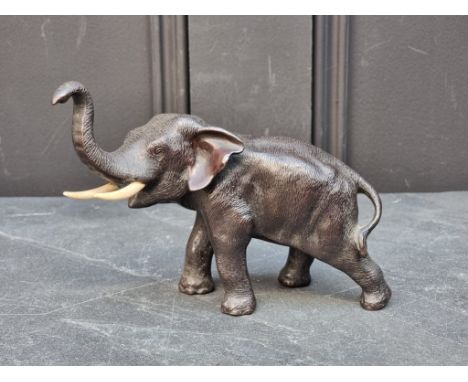 A small Japanese bronze elephant, with bone tusks, 18cm long.