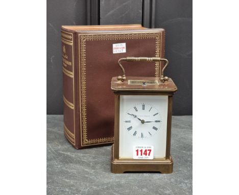 A large brass carriage clock, by Matthew Norman, with push button repeat, striking on a gong, boxed with key.