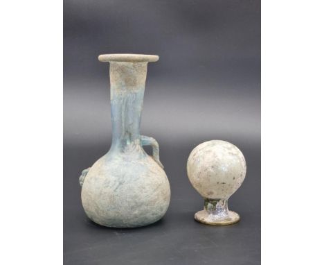Antiquities: a Roman style glass bottle, 19.5cm high; together with another glass finial, 9cm high. (2)