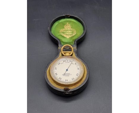 A Victorian gilt brass pocket barometer, by Callaghan, in leather case.