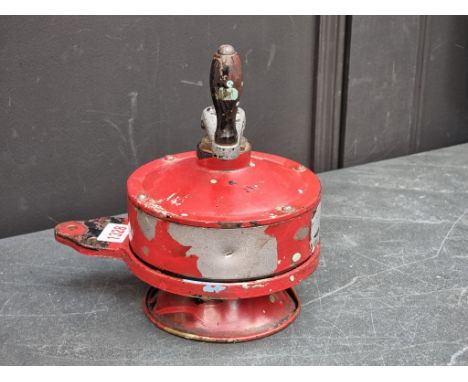 A vintage red painted brass and aluminium hand crank Klaxon alarm.