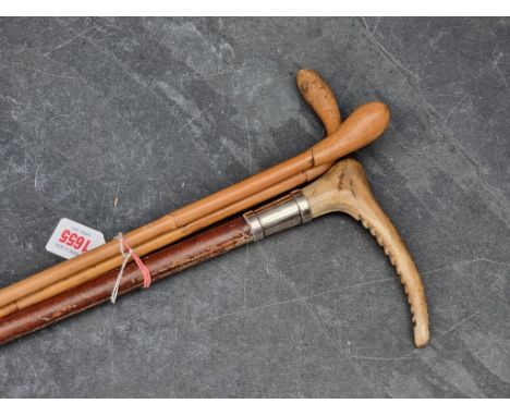 A silver mounted antler handled riding crop, inscribed 'Capt J Bryant R.F.A.'; together with two other canes. (3)
