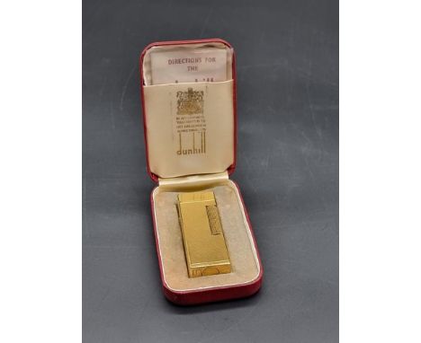 A Dunhill gilt metal lighter, boxed with instructions.