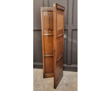 A 1950s carved oak panelled four-fold screen, each panel 168 x 46cm.