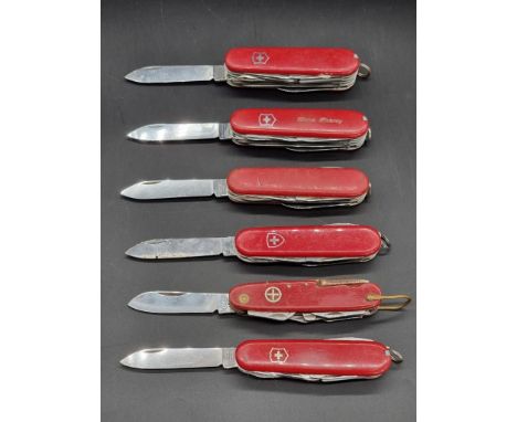 Six Swiss Army knives. 