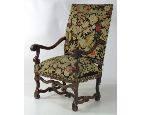 A large 19th Century carved walnut Armchair, in the early 17th Century style, with high back, and shaped base with scroll fee