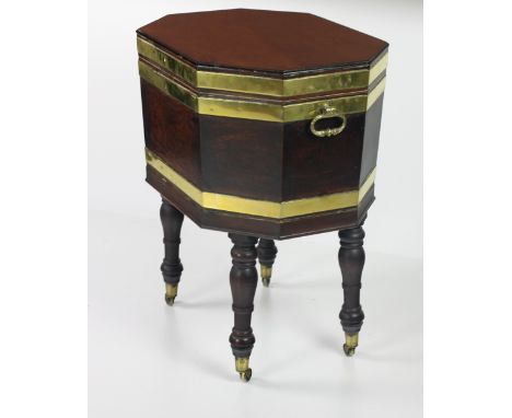 A very fine Irish Regency period large figured mahogany brass bound octagonal Wine Cooler, with compartmental lead lined inte