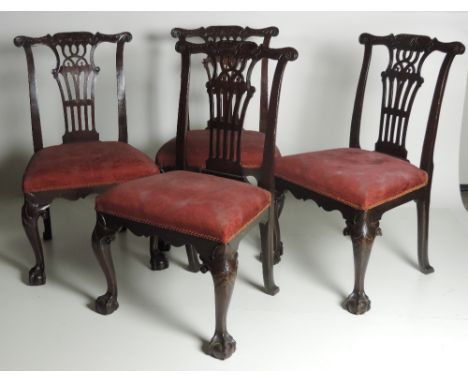 A very fine set of four early 19th Century Irish Chippendale style Side Chairs, with carved and pierced slat backs over uphol