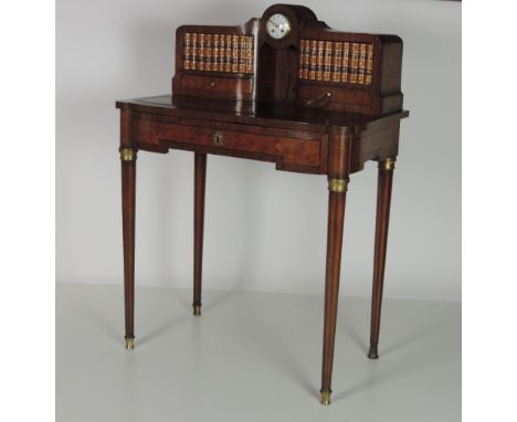 An attractive French style Ladies Writing Desk, the upper section with built in clock by Leroy of Paris, flanked by shelves o