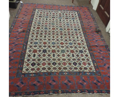 An attractive late 19th Century Oriental Rug, the ivory ground field with multiple designs and with a large wine ground borde