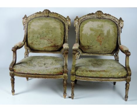 A large pair of fine quality English 19th Century carved giltwood Armchairs, the leaf and scroll carved back rail over an uph